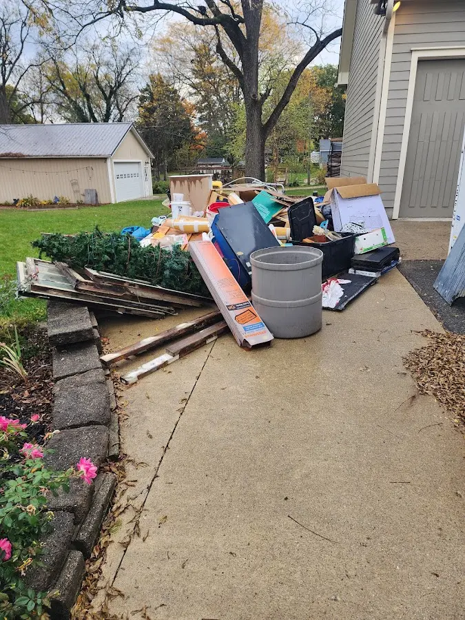 Dumpster being loaded with debris for Roofing Dumpster Rental in Wentzville